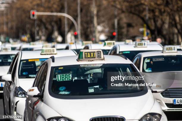 Taxi drivers demonstrate with their vehicles driving through downtown Madrid blocking traffic, protesting against the proposed regulation of their...