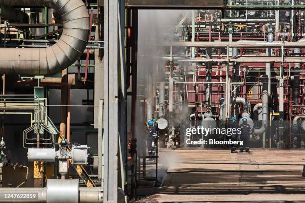 Employees wear ear protection at the wax Synthesis plant at the Sasol Ltd. Sasol One liquid fuels facility in Sasolburg, South Africa, on Thursday,...