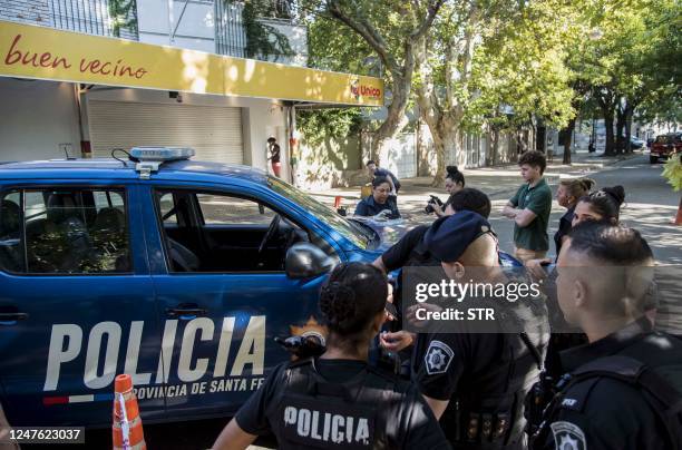 Police inspect a supermarket belonging to the family of Antonela Roccuzzo, the wife of Argentine football star Lionel Messi, after attackers fired...