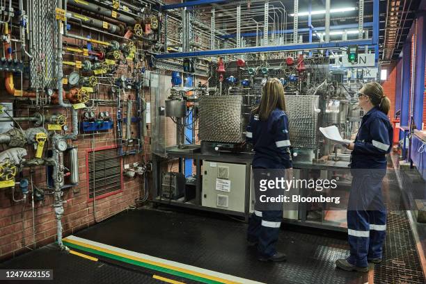 Employees inspect Fischer-Tropsch micro-reactors in a laboratory at the Sasol Ltd. Sasol One liquid fuels facility in Sasolburg, South Africa, on...