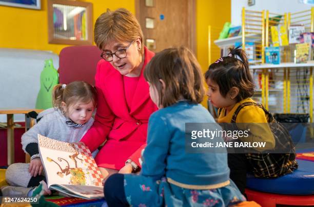 Scotland's First Minister Nicola Sturgeon reads to a group of young children during a visit to Wester Hailes Library in Edinburgh, Scotland on March...