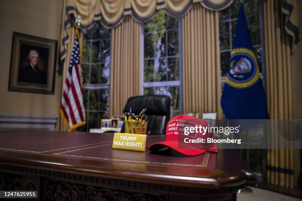 Hat supporting former US President Donald Trump on a replica of the Resolute Desk during the Conservative Political Action Conference in National...