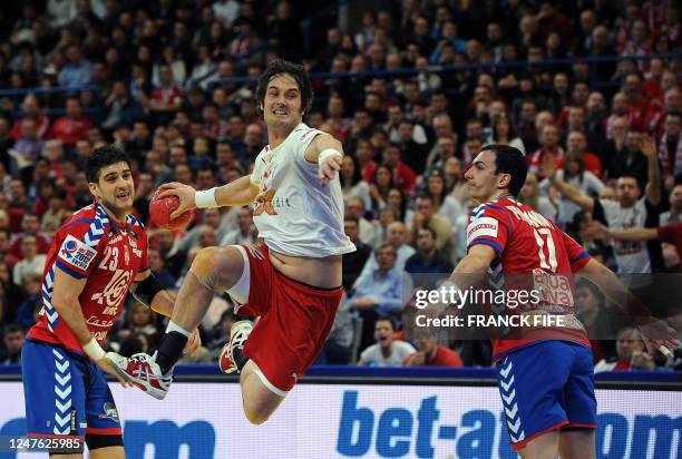 Denmark's Bo Spellerberg jumps to score in front of Serbia's Nenad Vuckovic and Rajko Prodanovic during the men's EHF Euro 2012 Handball Championship...