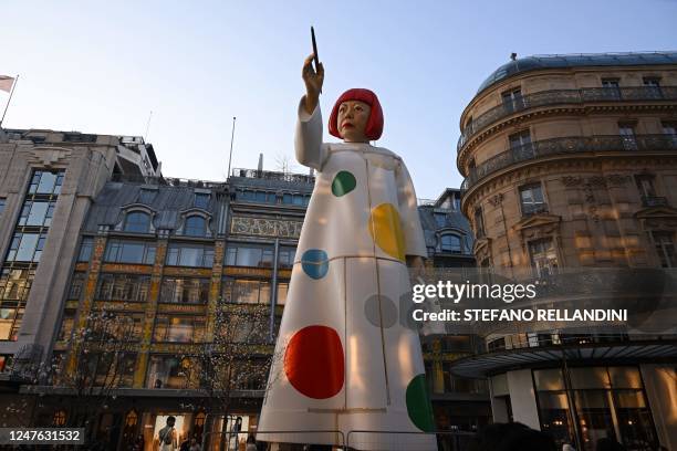 This photograph taken on March 2 shows a large statue depicting Japanese contemporary artist Yayoi Kusama pointing a paintbrush towards the French...