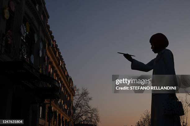 This photograph taken on March 2 shows a large statue depicting Japanese contemporary artist Yayoi Kusama pointing a paintbrush towards the French...
