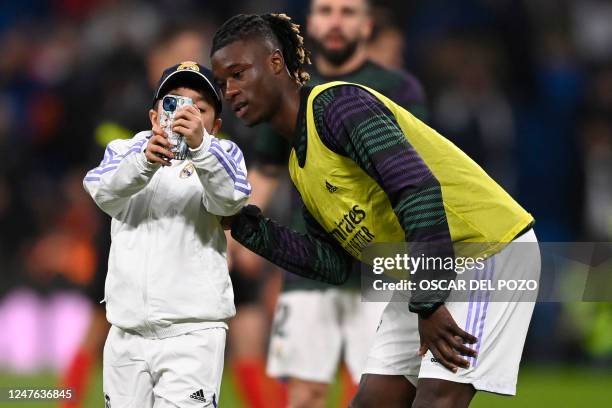 Young fan takes a selfie photo with Real Madrid's French midfielder Eduardo Camavinga ahead of the Copa del Rey semi final first Leg football match...