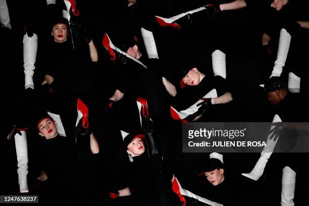 Dancers, wearing Louboutin shoes, perform to celebrate the 30th anniversary of the red sole on the sidelines of the Paris Fashion Week at the Opera...