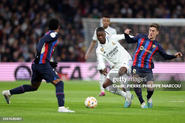 Barcelona's Spanish midfielder Gavi vies with Real Madrid's French midfielder Eduardo Camavinga during the Copa del Rey semi final first Leg football...