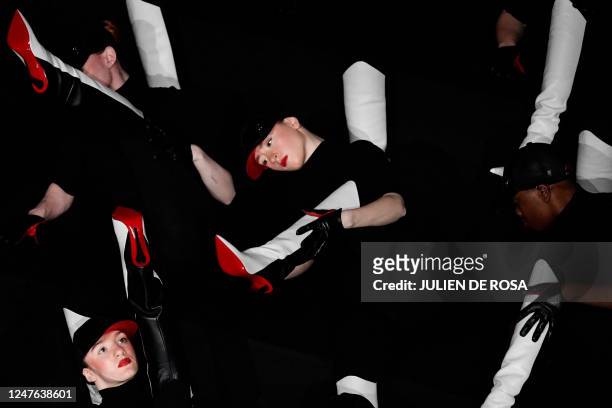 Dancers, wearing Louboutin shoes, perform to celebrate the 30th anniversary of the red sole on the sidelines of the Paris Fashion Week at the Opera...