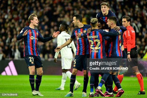 Barcelona's Ivorian midfielder Franck Kessie celebrates with teammates after scoring his team's first goal during the Copa del Rey semi final first...