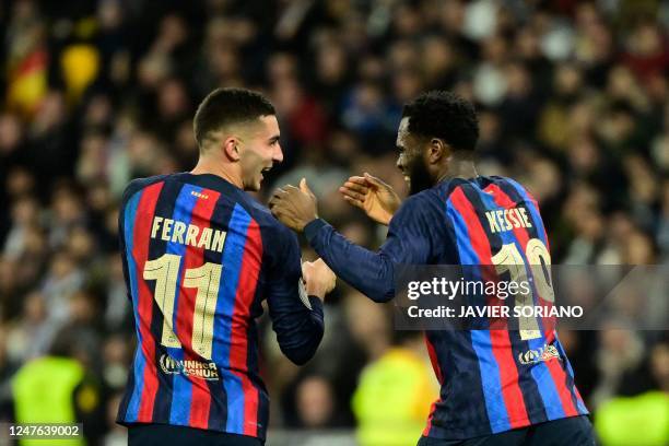 Barcelona's Ivorian midfielder Franck Kessie celebrates with Barcelona's Spanish forward Ferran Torres after scoring his team's first goal during the...