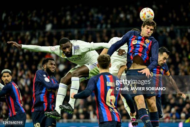 Real Madrid's German defender Antonio Rudiger and Barcelona's Spanish defender Marcos Alonso jump for the ball during the Copa del Rey semi final...