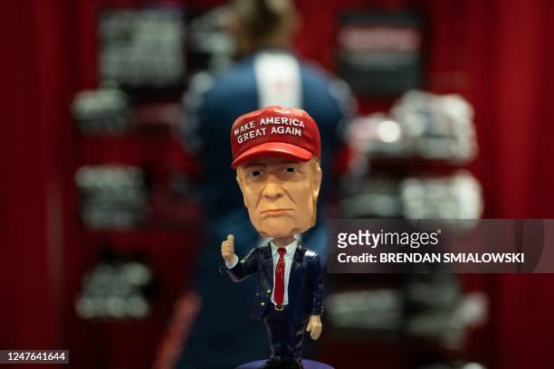 Bobblehead of former US President Donald Trump is seen at a vendors booth during the Conservative Political Action Coalition's annual meeting at the...