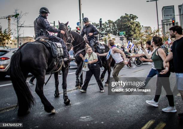 Horse-mounted Israeli police officers push back protesters during a demonstration in Tel Aviv. Israeli protesters gathered in some areas in Tel Aviv...