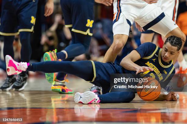 Jett Howard of the Michigan Wolverines tries to keep his dribble alive after falling during the first half against the Illinois Fighting Illini at...