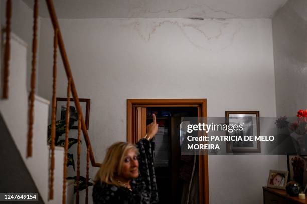 Maria de Jesus Alves Costa, 68 years old, shows the ceiling of her house covered in mold due to the level of humidity in Costa da Caparica, outskirts...