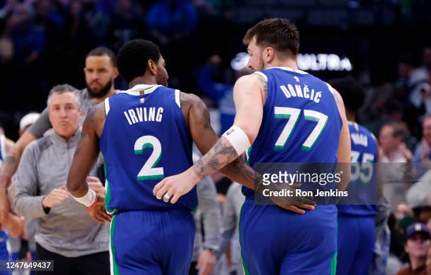 Kyrie Irving and teammate Luka Doncic of the Dallas Mavericks celebrate against the Philadelphia 76ers in the second half at American Airlines Center...