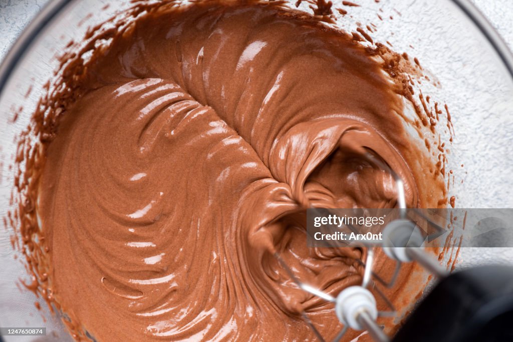 Mixing chocolate cake batter with electric mixer