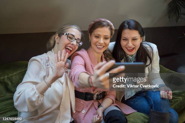 women taking a selfie in a cafe - aleksandra cvetkovic stock pictures, royalty-free photos & images
