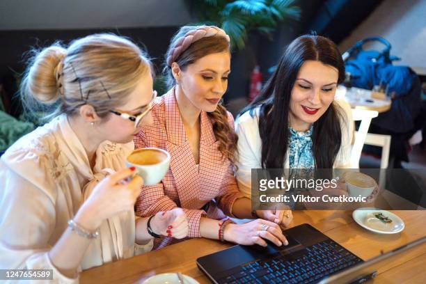 young happy business women using laptop - aleksandra cvetkovic stock pictures, royalty-free photos & images