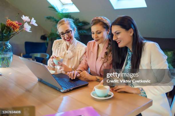 young happy business women using laptop - aleksandra cvetkovic stock pictures, royalty-free photos & images