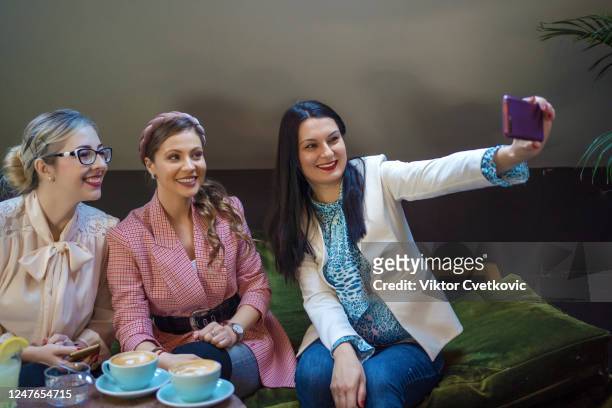 women taking a selfie in a cafe - aleksandra cvetkovic stock pictures, royalty-free photos & images