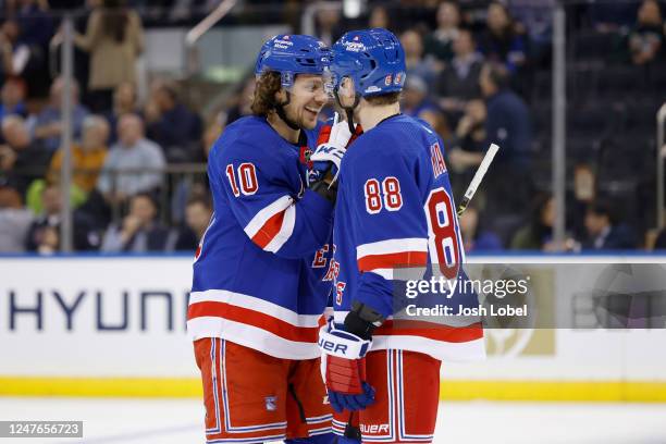 Artemi Panarin of the New York Rangers laughs with new teammate Patrick Kane during the first period against the Ottawa Senators at Madison Square...