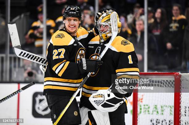 Jeremy Swayman and Hampus Lindholm of the Boston Bruins celebrate a win against the Buffalo Sabres at TD Garden on March 02, 2023 in Boston,...