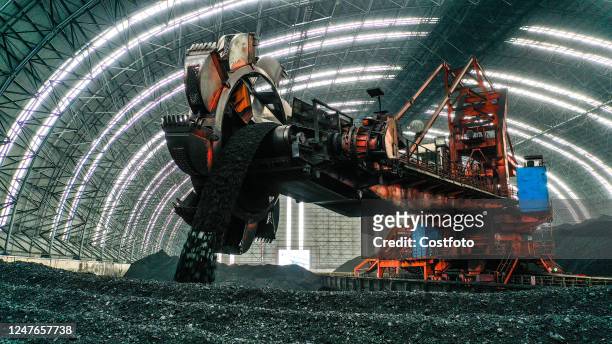 An inner bucket turbine of Jiangxi Fengcheng Power Generation Company piles coal at a fully enclosed coal yard in Yichun, Jiangxi province, China,...