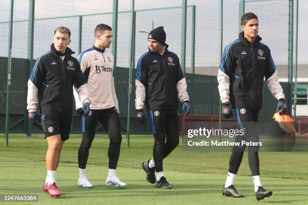 Lisandro Martinez, Diogo Dalot, Casemiro & Raphael Varane of Manchester United walk out to a Manchester United first team training session at...