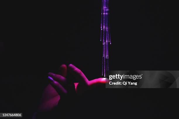 hand touching red fiber optics - permission concept stock-fotos und bilder