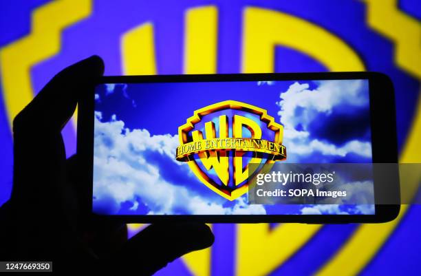 In this photo illustration, a Warner Bros. Entertainment Inc. Logo is seen on a smartphone screen.