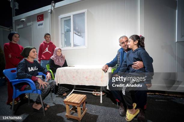 Earthquake survivors are seen in front of the container house at container city built for the earthquake survivors in Antakya district of Hatay after...