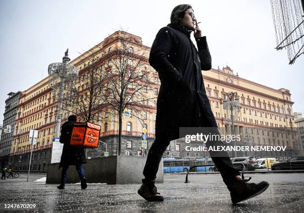 Man walks past the headquarters of the Federal Security Service , the successor agency to the KGB, and Lubyanka Square in front of it in central...