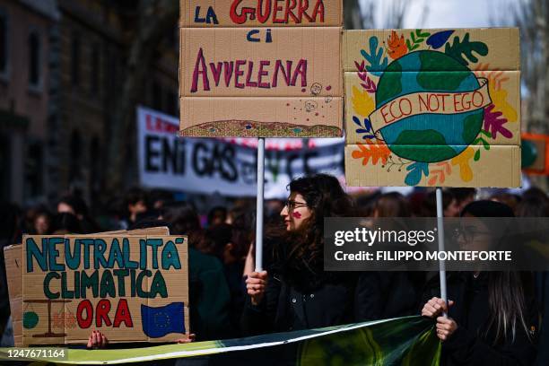 Activists of the environmental 'Fridays for Future' movement march during a demonstration for climate action on March 3, 2023 in Rome. - The placards...