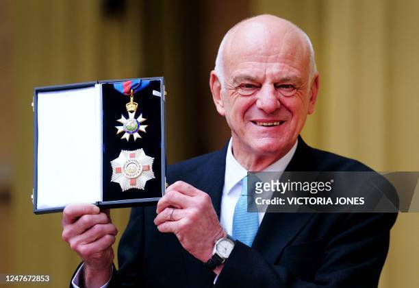 David Nabarro, World Health Organisation Special Envoy for Covid-19 Prevention and Response, poses with his medal and insignia after being appointed...