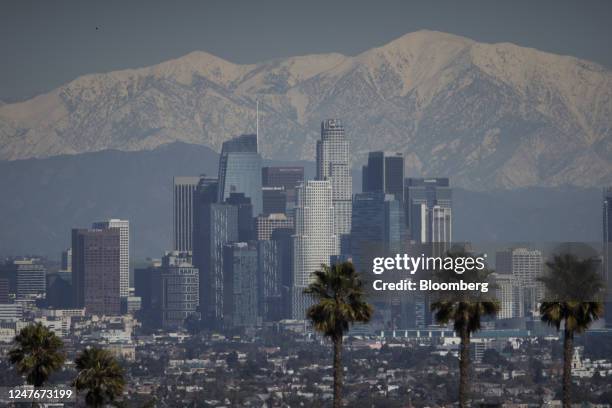 The snow-covered San Gabriel mountain range past the downtown Los Angeles skyline after a winter storm in Los Angeles, California, US, on Thursday,...