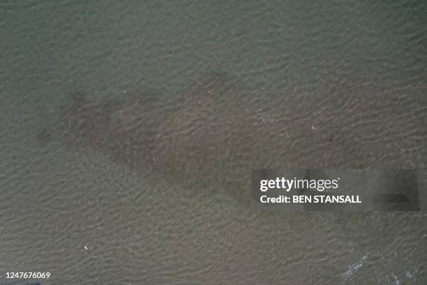 An aerial view shows discoloured water being released from the Thames Water Long Reach water treatment facility on the banks of the Thames estuary in...