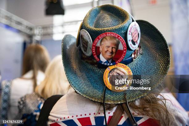 An attendee wears a hat with buttons supporting former US President Donald Trump during the Conservative Political Action Conference in National...