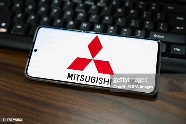 In this photo illustration, a Mitsubishi logo is displayed on the screen of a smartphone.