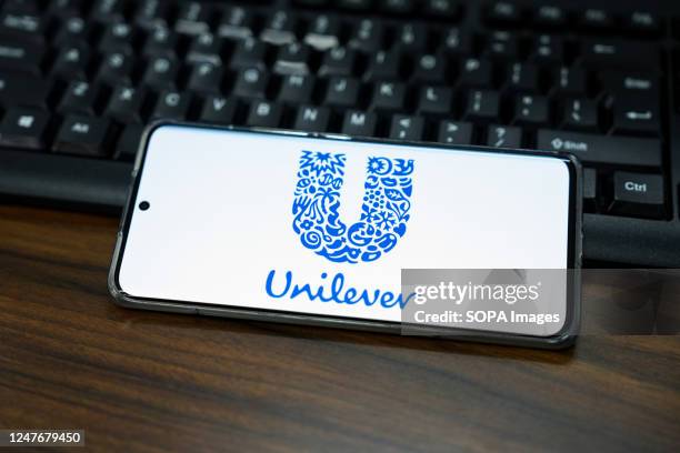 In this photo illustration, a Unilever logo is displayed on the screen of a smartphone.