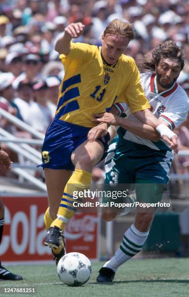 Kennet Andersson of Sweden holds off the challenge from Trifon Ivanov of Bulgaria during the FIFA World Cup third place play-off match at the Rose...