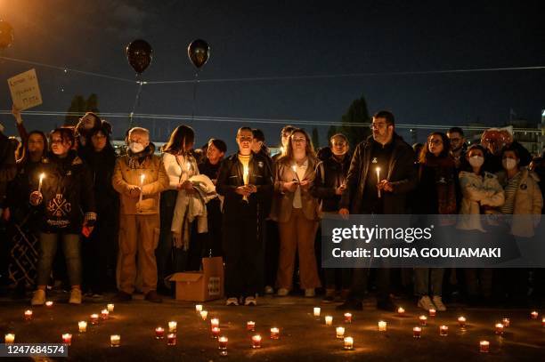 Protesters hold candles during a silent demonstration in front of the Greek parliament in Athens on March 3 following the deadly accident near the...