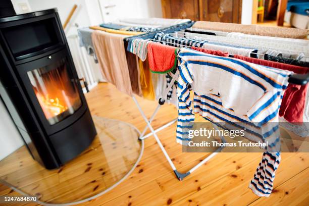 Laundry is dried on a drying rack in front of a wood stove on March 03, 2023 in Berlin, Germany.