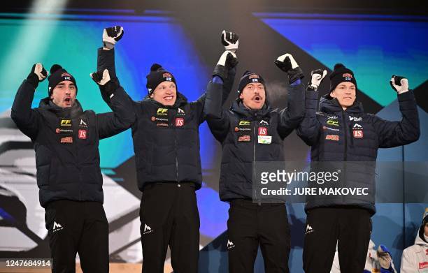 Silver medallist team Finland celebrates on the podium during the award ceremony of the Mens Cross-Country 4x10km Relay Classic/Free competition of...