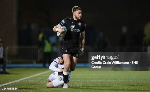 Warriors' Ollie Smith is tackled by Zebre's Simone Gesi during a BKT United Rugby Championship match between Glasgow Warriors and Zebre Parma at...
