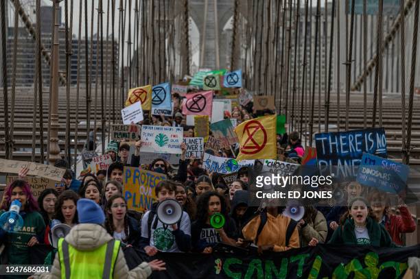 Activists from climate group Fridays for Future shout slogans and march during a Global Climate Strike in New York on March 3, 2023.