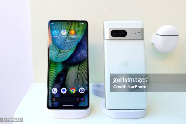 The Pixel 7, the newest mid-range smartphone by Google, exhibited by the Pixel Buds Pro on the Android Smart Home display during the Mobile World...
