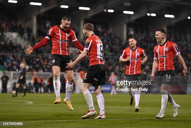 Dublin , Ireland - 3 March 2023; Jamie McGonigle of Derry City, centre, celebrates with teammate Ryan Graydon, left, after scoring their side's...