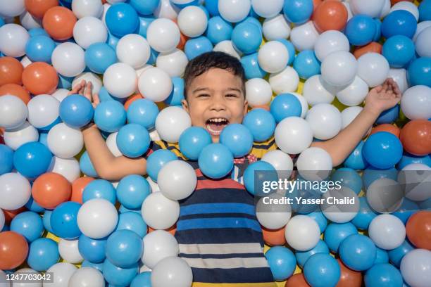 boy in ball pit - ball pit stock pictures, royalty-free photos & images